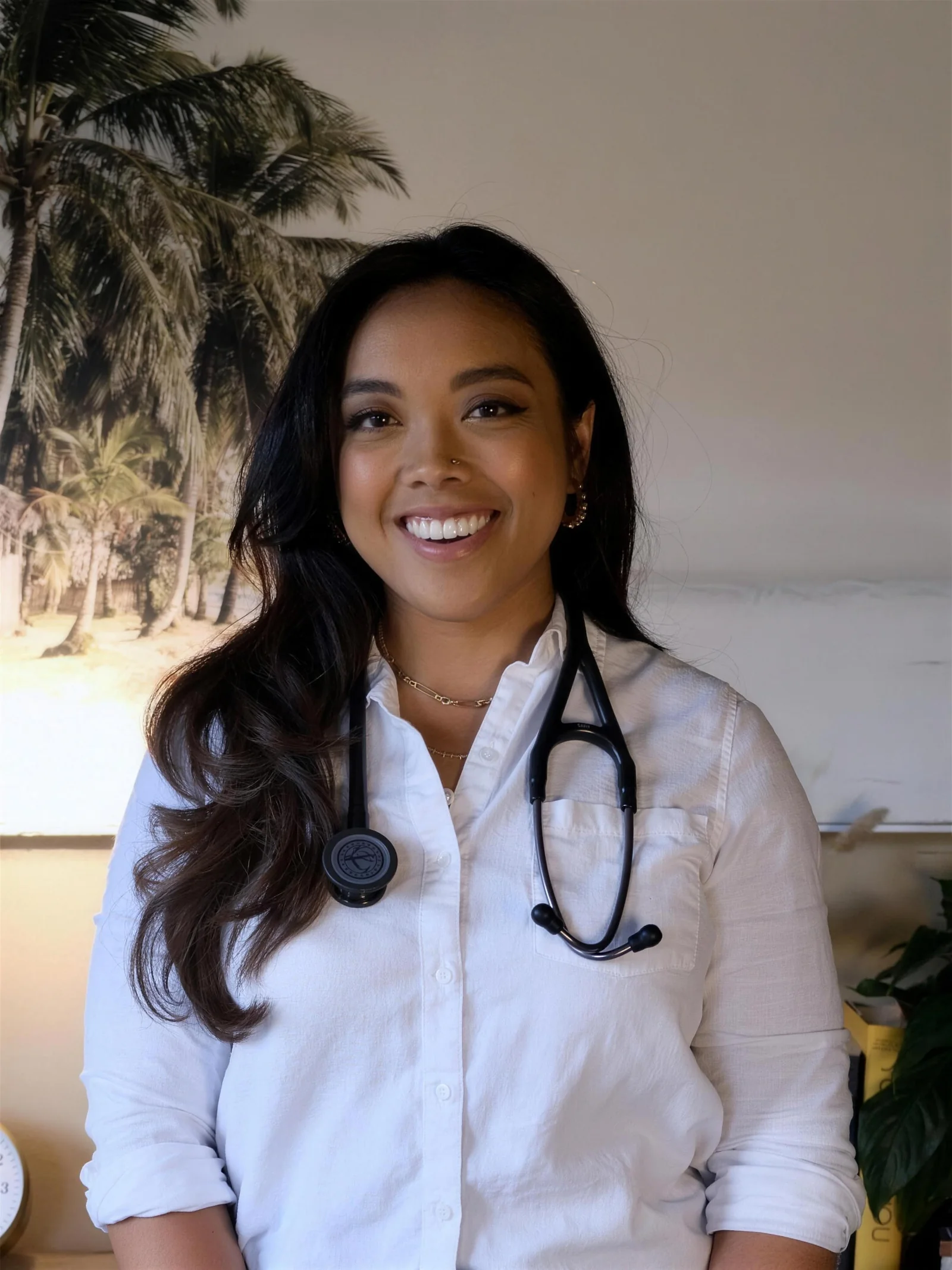 Dr. Lexi Gonzales, smiling, in a white shirt with a stethoscope